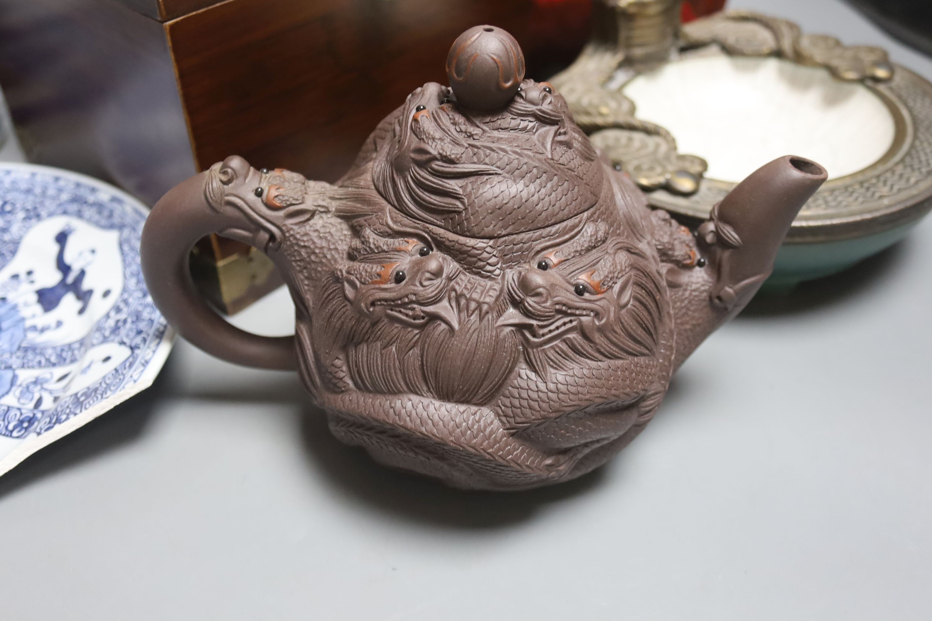 A Chinese Yixing teapot, similar blue and white teapot, blue and white dish and a candle holder, blue and white tea pot 14 cms high.